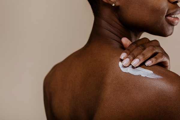 applying_lotion_african_american_woman
